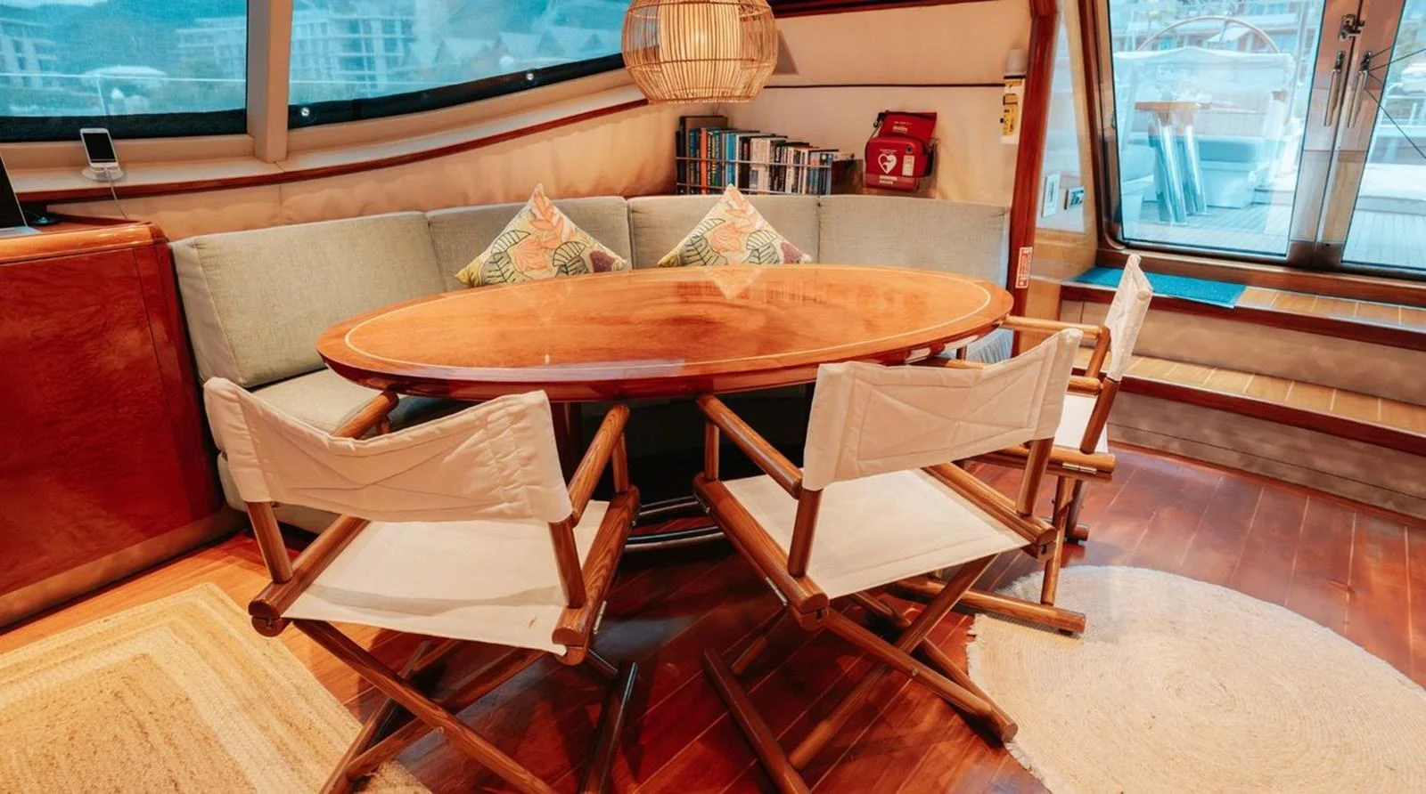 The salon features a cozy dining area with a wooden table and comfortable chairs, perfect for intimate gatherings. aboard THANDEKA Yacht for Sale