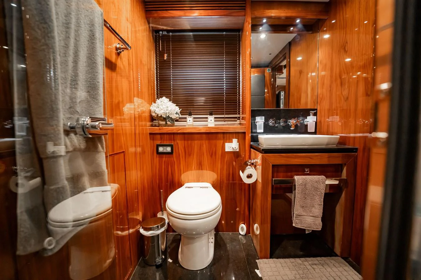 A luxurious yacht bathroom featuring elegant wood paneling and modern fixtures. aboard BLUE Yacht for Sale