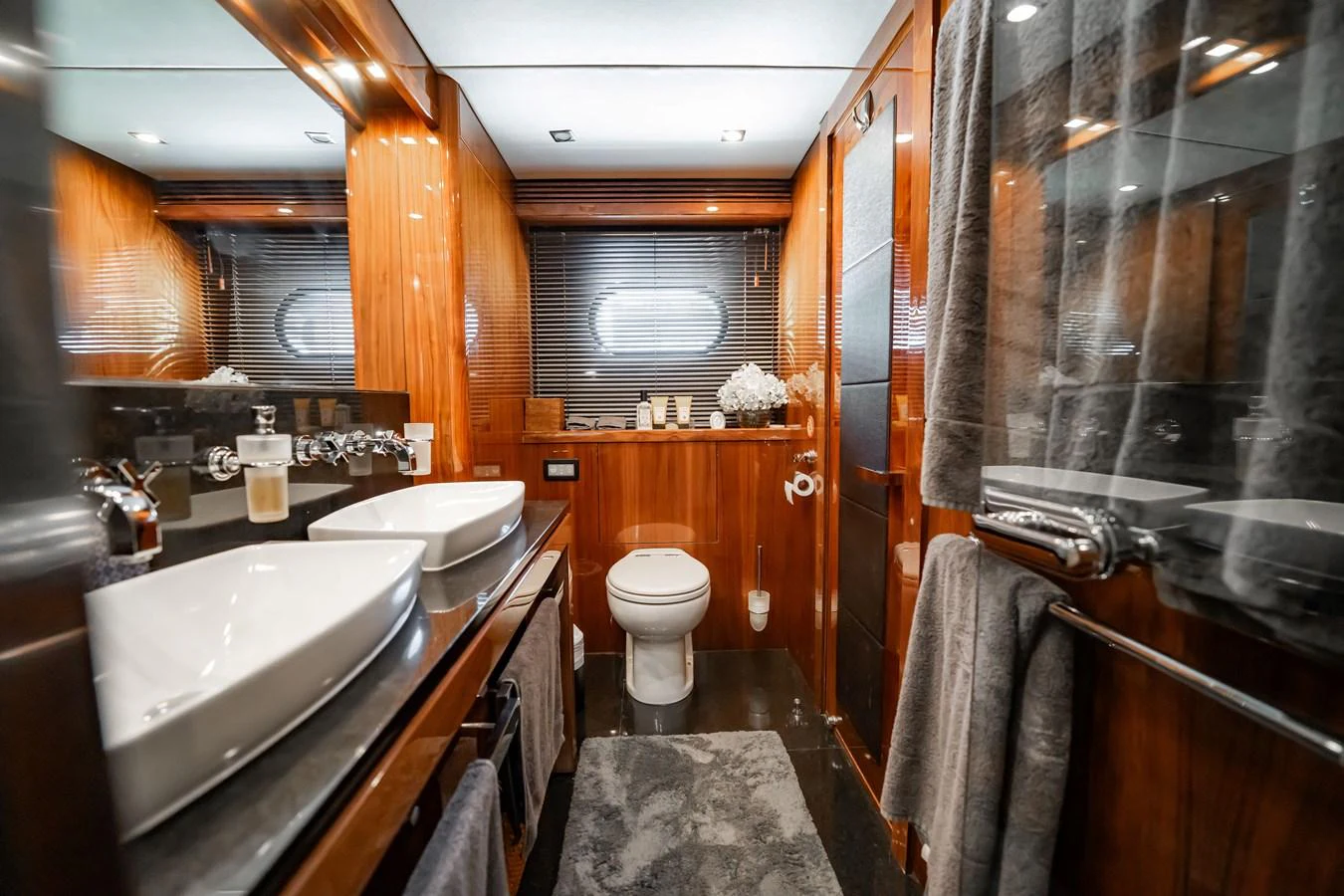 The yacht's bathroom features luxurious wooden finishes and modern amenities. aboard BLUE Yacht for Sale