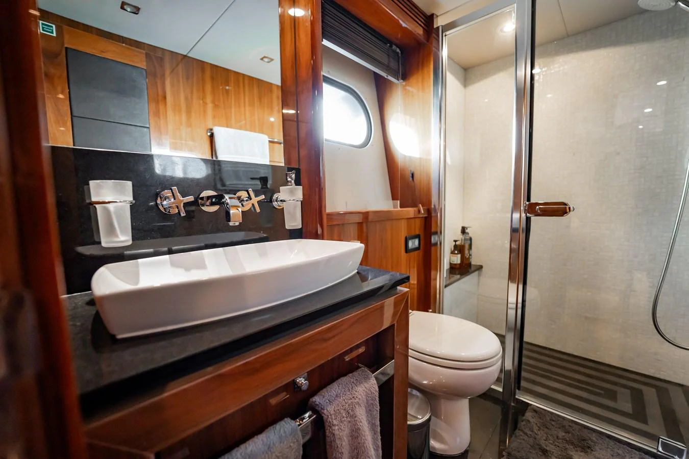 The yacht's bathroom features a sleek design with modern fixtures and a spacious shower area. aboard BLUE Yacht for Sale