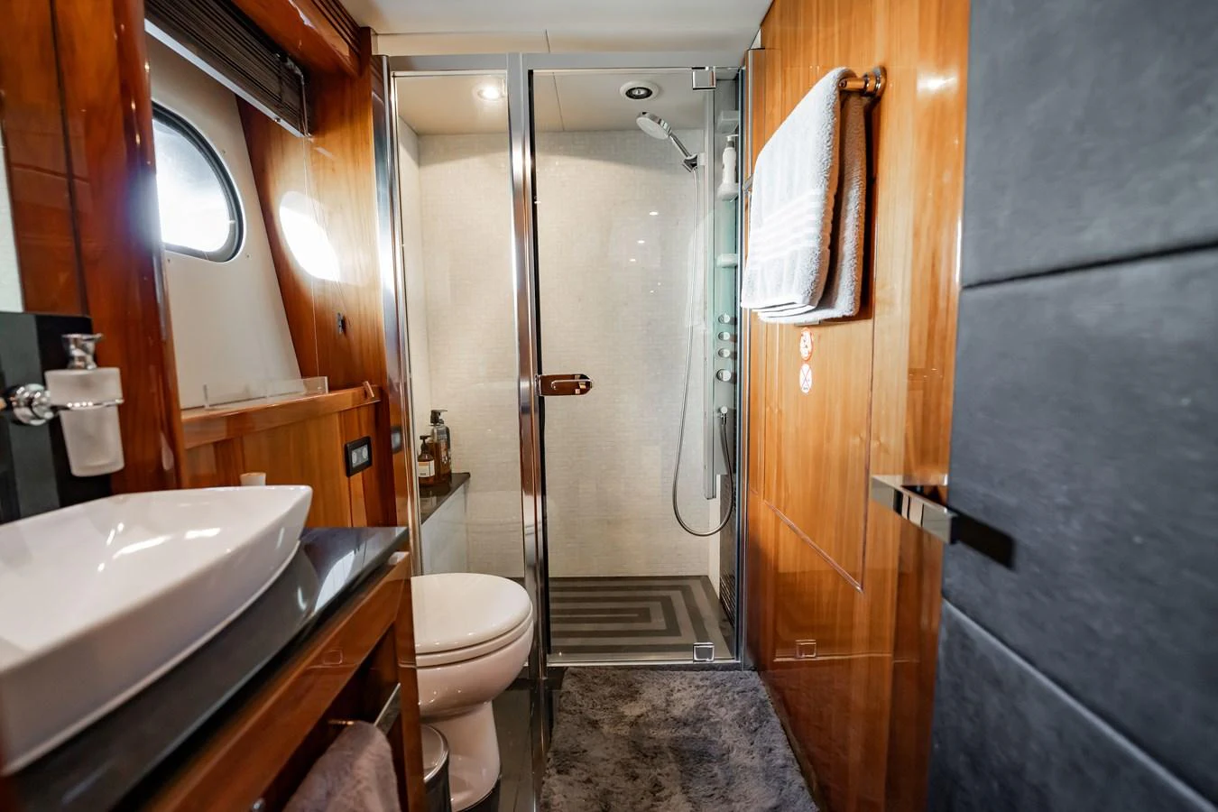 The yacht's bathroom features a sleek design with a glass-enclosed shower and modern fixtures. aboard BLUE Yacht for Sale