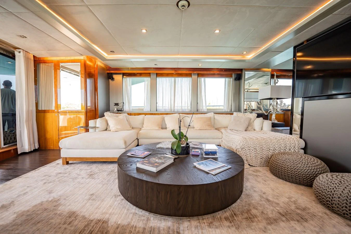 The salon features a spacious and elegant seating area with modern decor and ample natural light. aboard BLUE Yacht for Sale