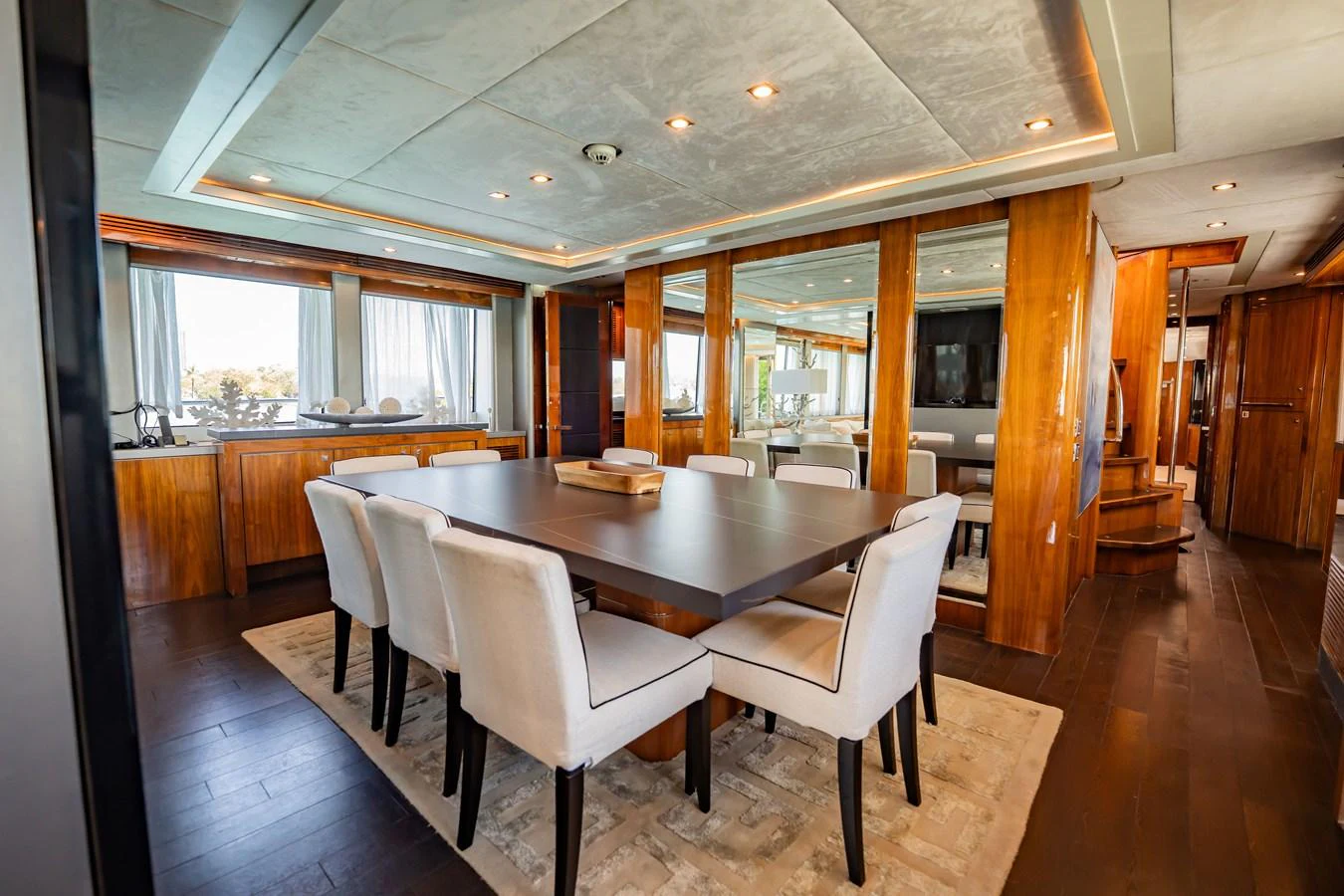The yacht's dining area features a spacious table with comfortable seating and elegant wooden accents. aboard BLUE Yacht for Sale