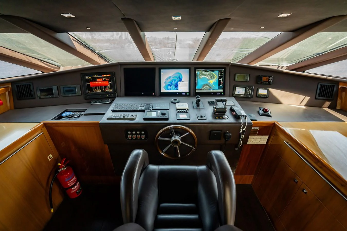 The helm station features advanced navigation equipment and a comfortable captain's chair. aboard BLUE Yacht for Sale