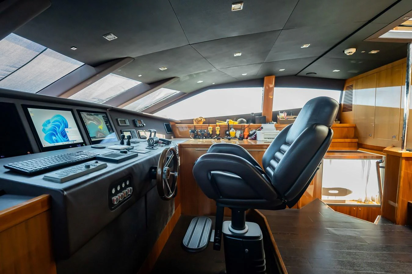 The helm station features advanced navigation equipment and a comfortable captain's chair, offering a commanding view for smooth sailing. aboard BLUE Yacht for Sale