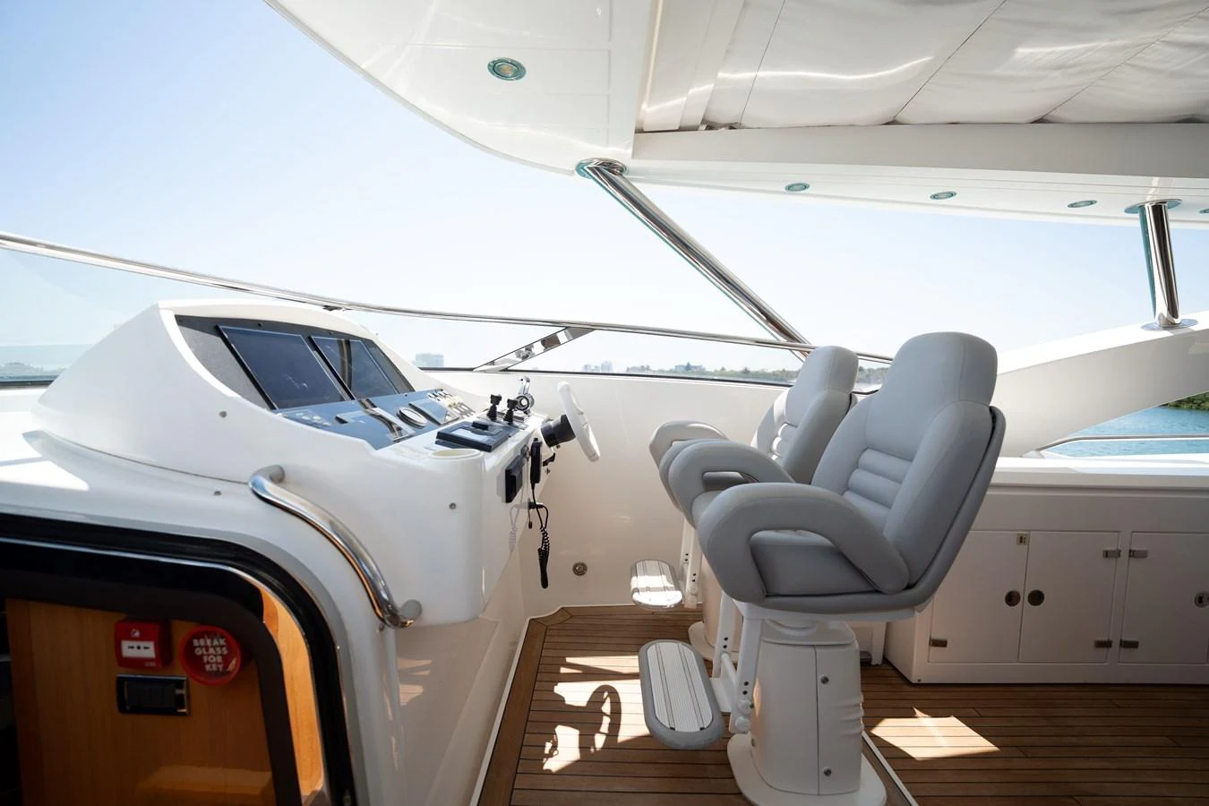 The helm station features modern navigation equipment and comfortable seating with a panoramic view. aboard BLUE Yacht for Sale