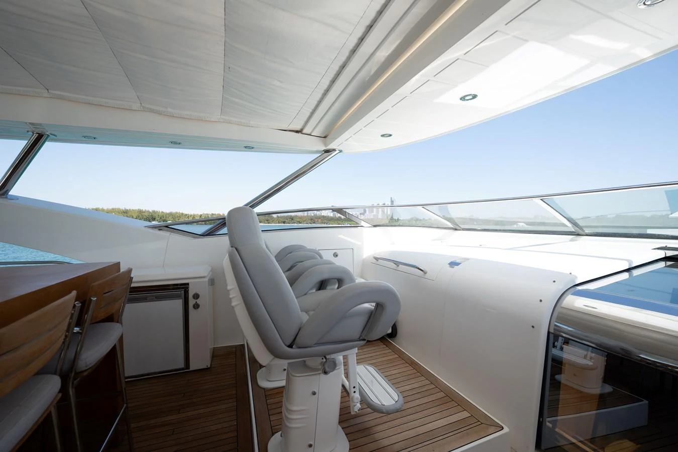 The helm area features modern seating and state-of-the-art navigation equipment, offering a commanding view of the surroundings. aboard BLUE Yacht for Sale