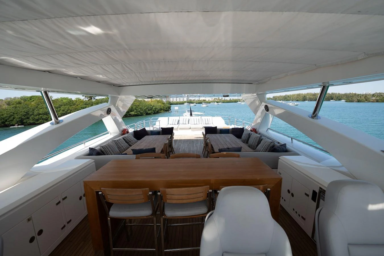 The flybridge offers a spacious and shaded area with comfortable seating and a dining table, perfect for relaxation and socializing. aboard BLUE Yacht for Sale