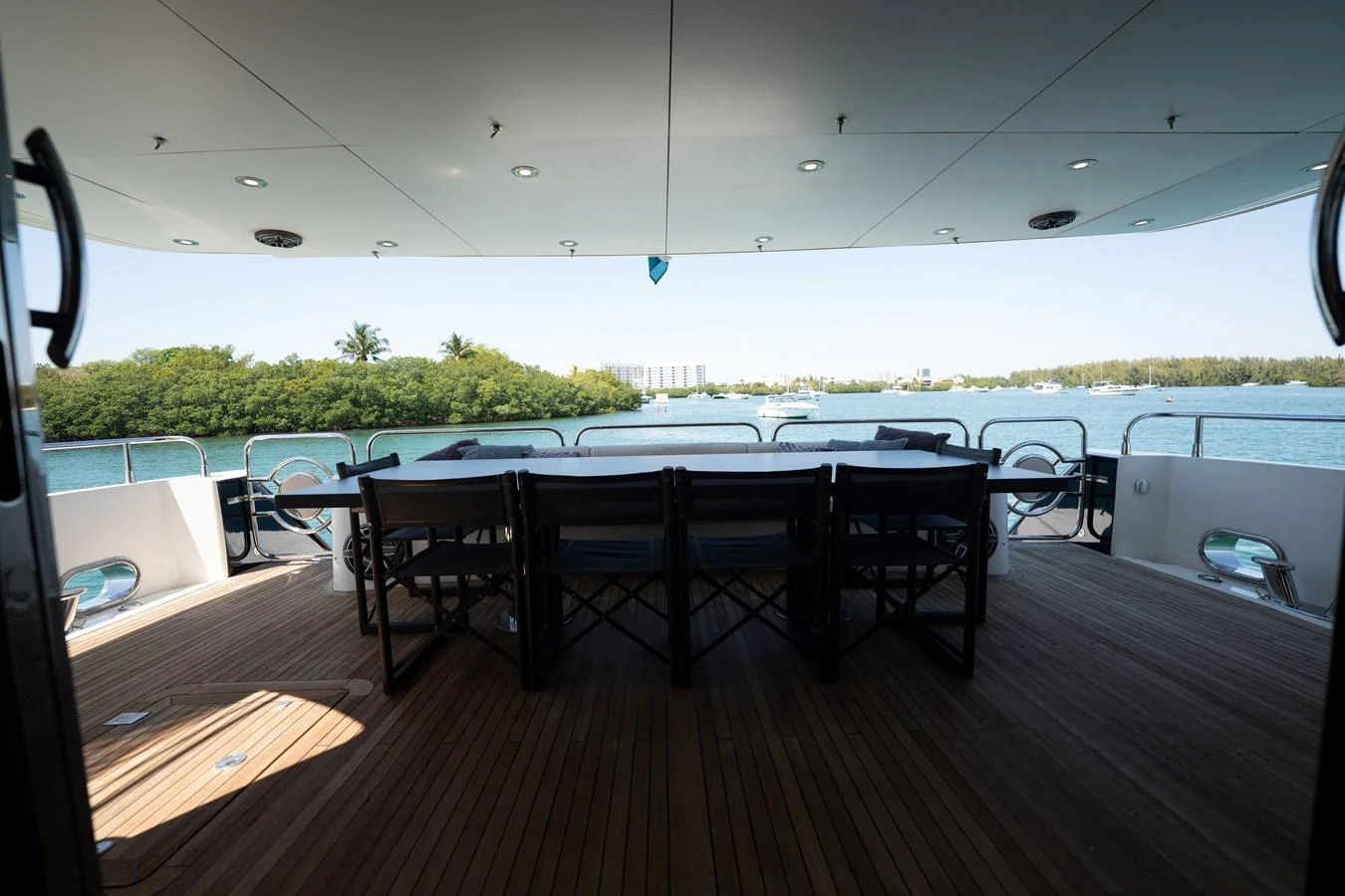 The aft deck offers a spacious and shaded area for dining with a stunning view of the water. aboard BLUE Yacht for Sale