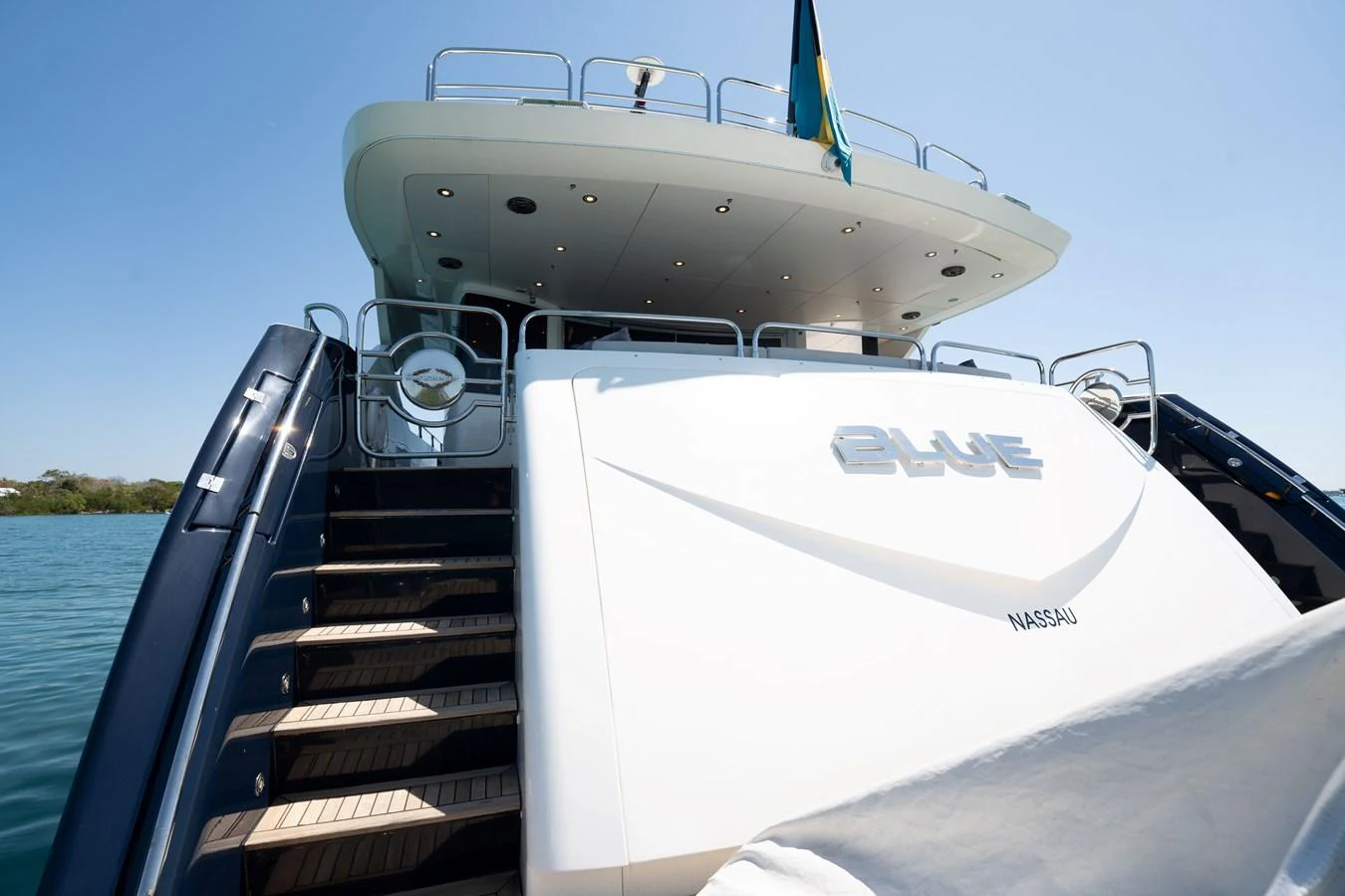 The yacht's stern features a spacious swim platform and elegant steps leading up to the main deck. aboard BLUE Yacht for Sale