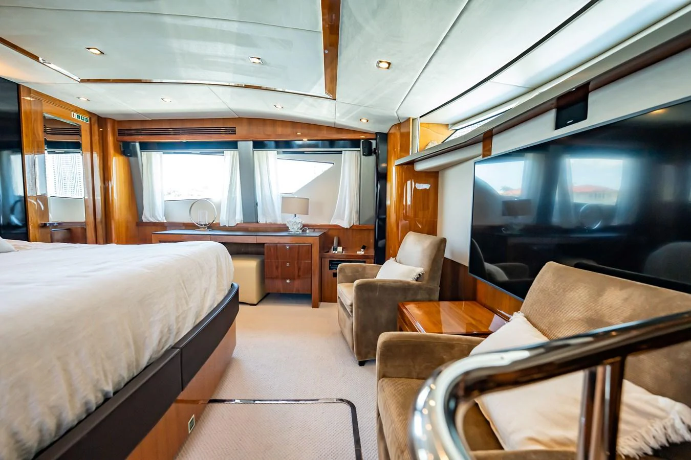 The stateroom features a luxurious bed, comfortable seating, and ample natural light. aboard BLUE Yacht for Sale
