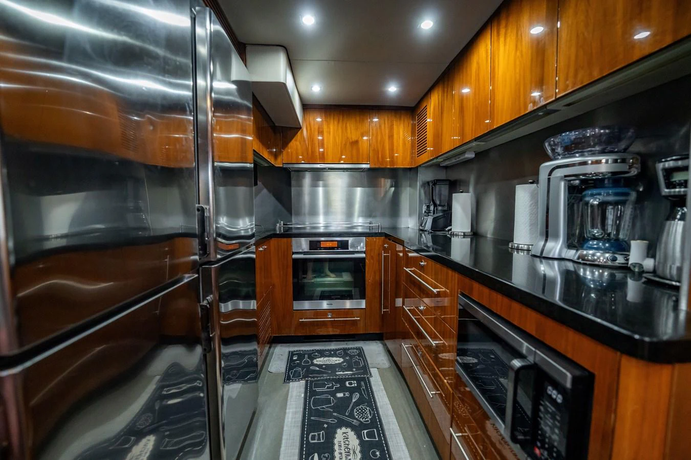 The yacht's galley is equipped with modern appliances and sleek cabinetry, offering a stylish and functional cooking space. aboard BLUE Yacht for Sale