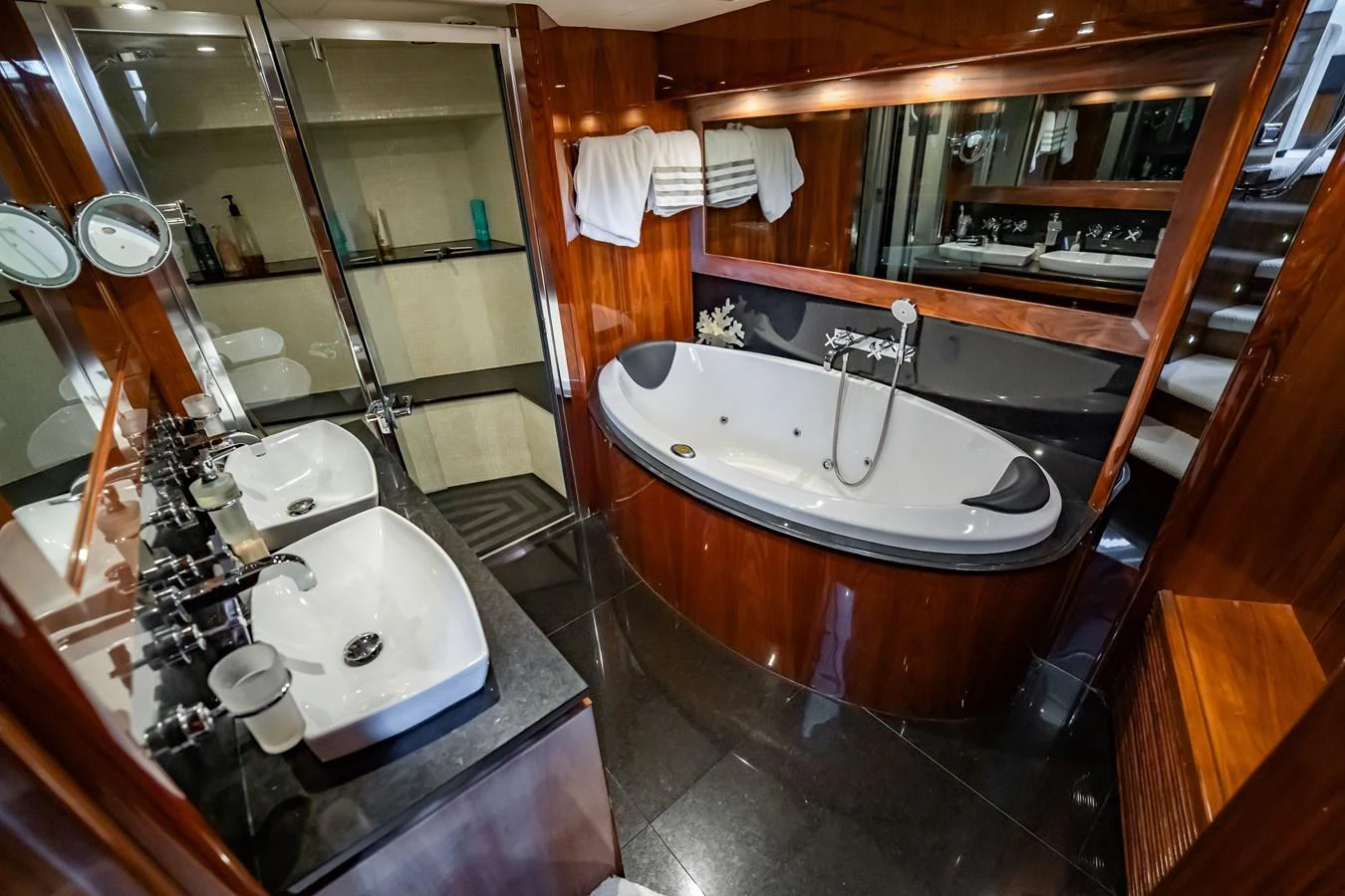 A luxurious yacht bathroom featuring a large bathtub and dual sinks with elegant fixtures. aboard BLUE Yacht for Sale