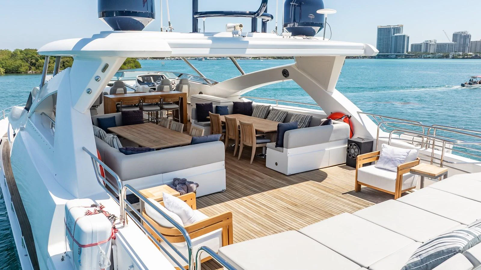 The spacious aft deck features elegant seating and dining areas with a stunning view of the water. aboard BLUE Yacht for Sale