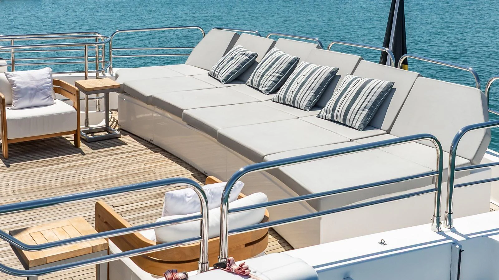 The sundeck features plush seating and sun loungers, perfect for relaxation under the sun. aboard BLUE Yacht for Sale