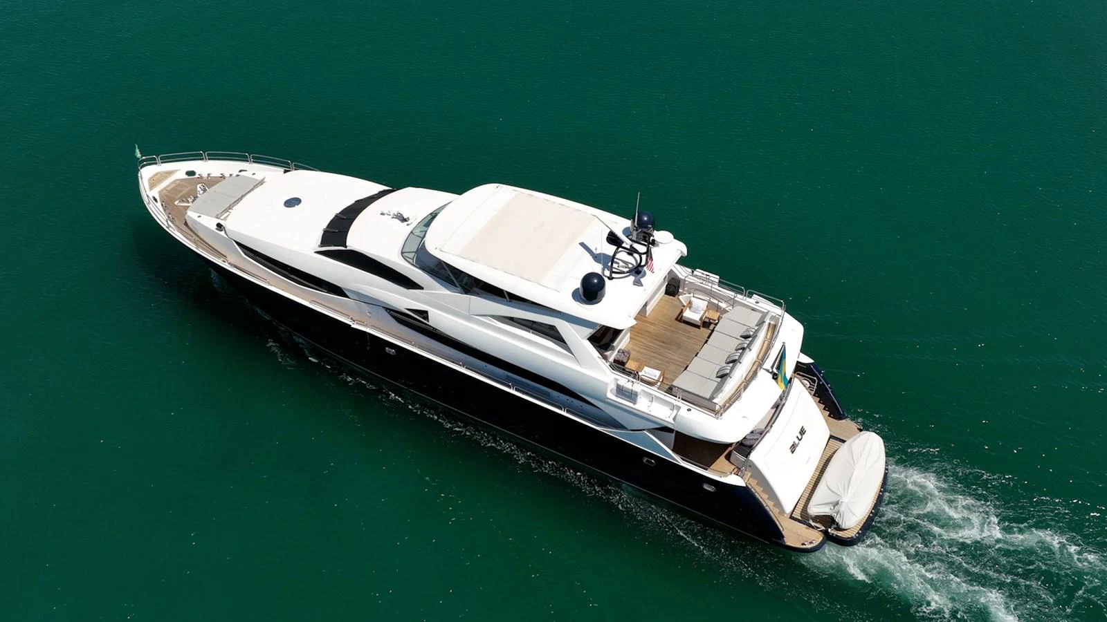 A sleek and modern yacht cruises gracefully on calm waters, showcasing its luxurious design and spacious deck areas. aboard BLUE Yacht for Sale