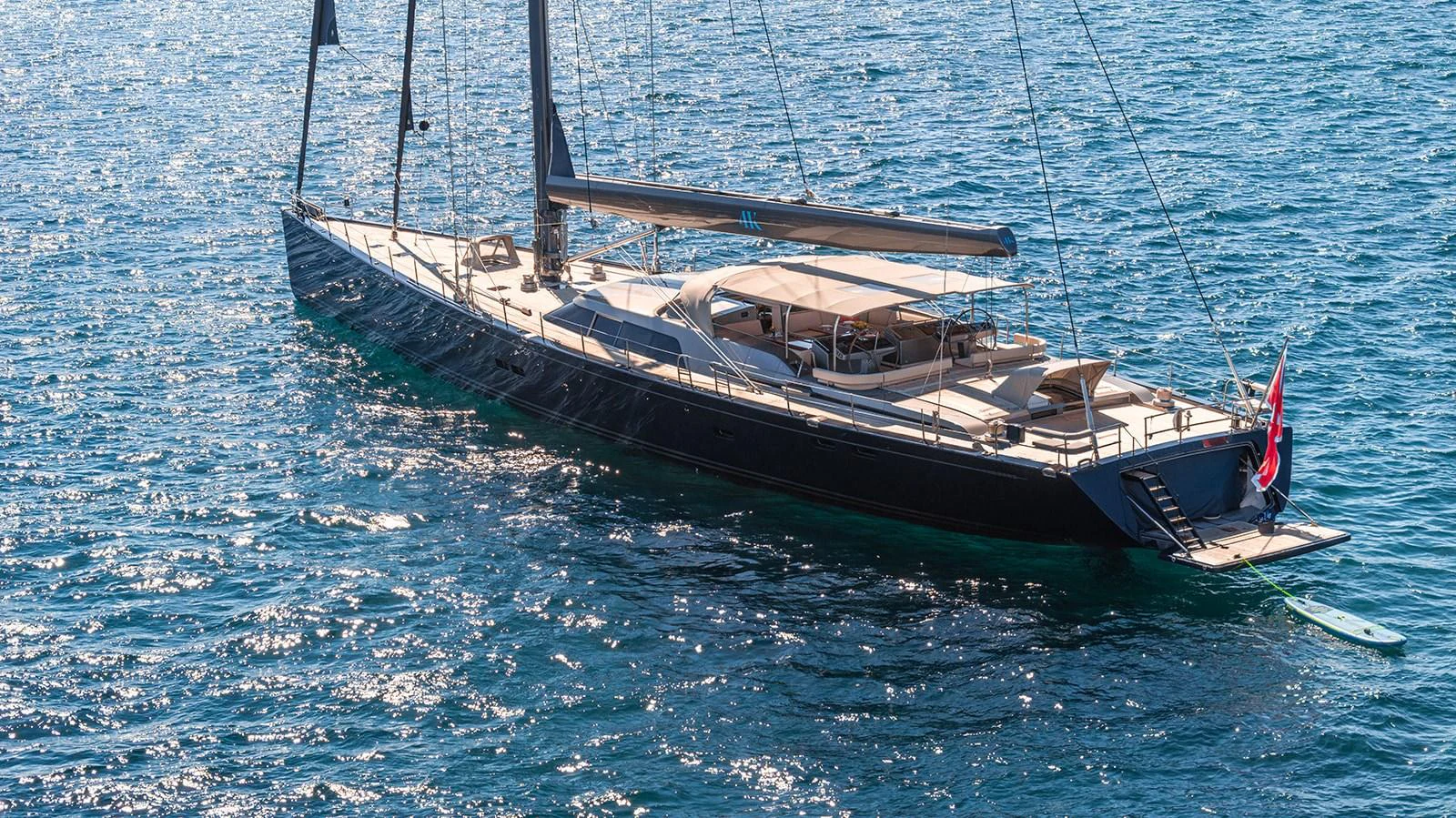 A sleek and modern yacht glides gracefully on the shimmering blue water. aboard 4K Yacht for Sale