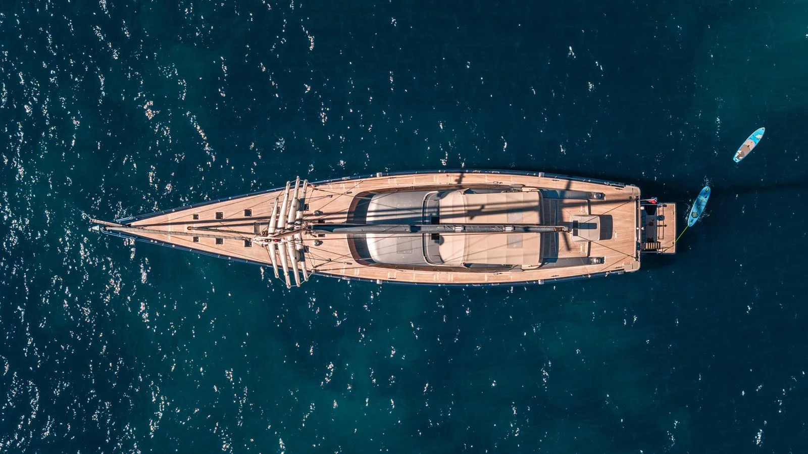 An aerial view of a sleek yacht cruising through deep blue waters. aboard 4K Yacht for Sale