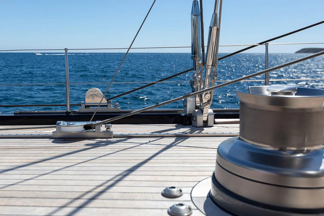 A close-up view of the yacht's deck showcasing the winches and rigging against a backdrop of the open sea. aboard 4K Yacht for Sale