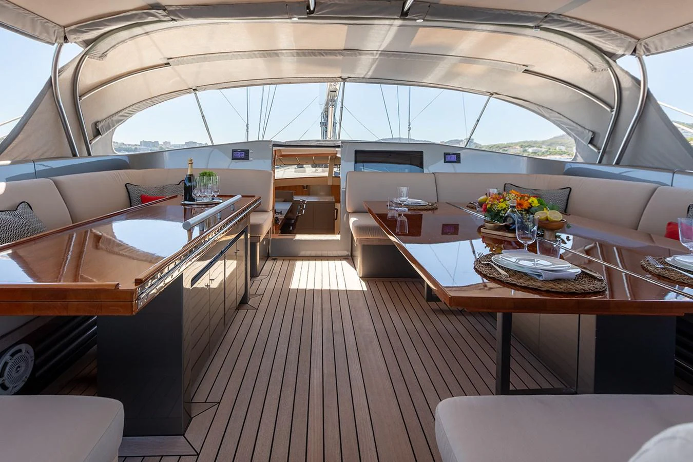 The yacht's dining area features elegant wooden tables and comfortable seating under a shaded canopy. aboard 4K Yacht for Sale
