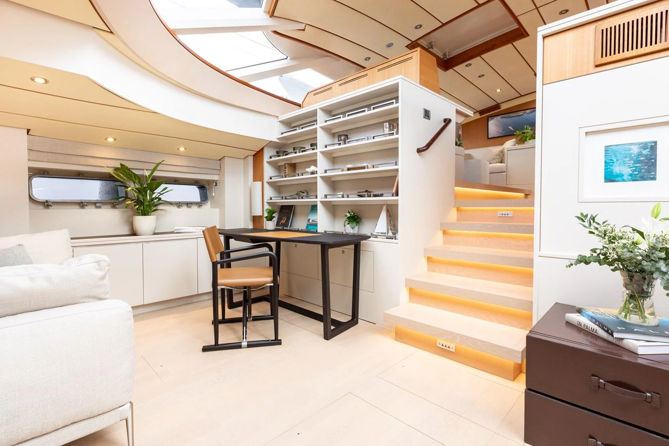 The salon features a modern design with ample natural light and elegant furnishings. aboard 4K Yacht for Sale