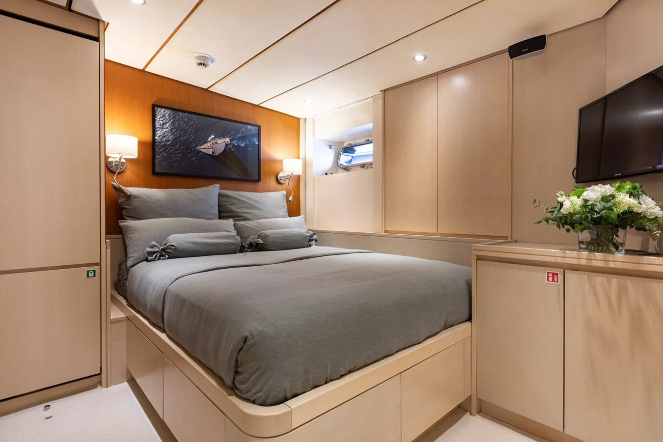 The stateroom features a comfortable bed with elegant bedding and modern decor. aboard 4K Yacht for Sale