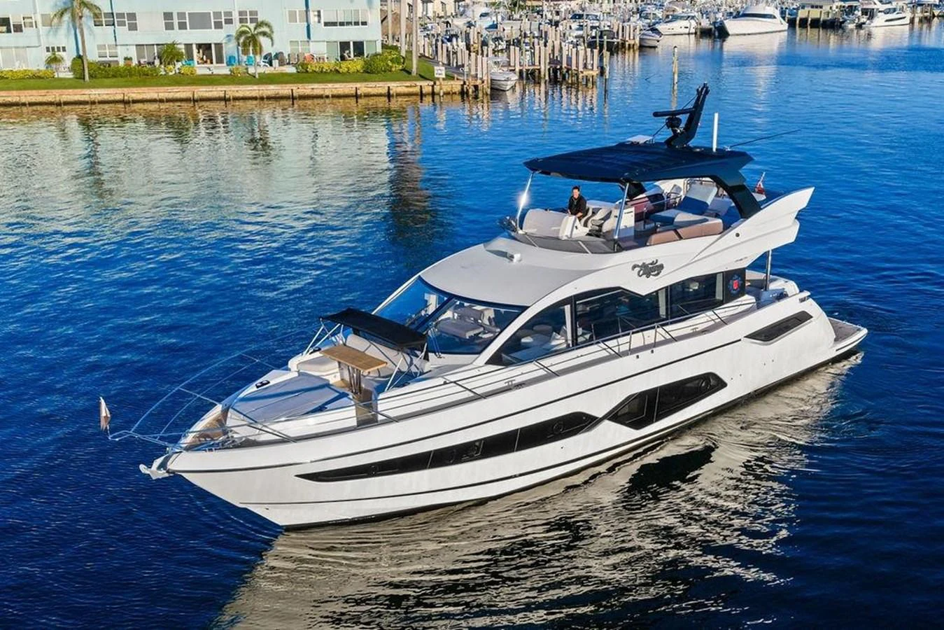 A sleek and modern yacht cruising in a serene marina setting. aboard ELLIGANCE Yacht for Sale