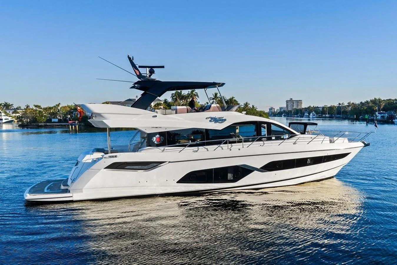 A sleek and modern yacht cruising on calm waters under a clear blue sky. aboard ELLIGANCE Yacht for Sale