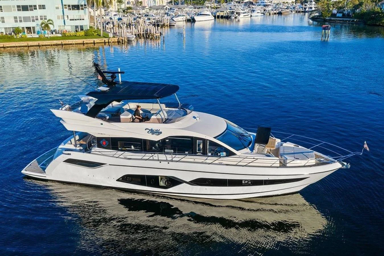 A sleek and modern yacht glides gracefully on calm waters, showcasing its luxurious design and spacious decks. aboard ELLIGANCE Yacht for Sale