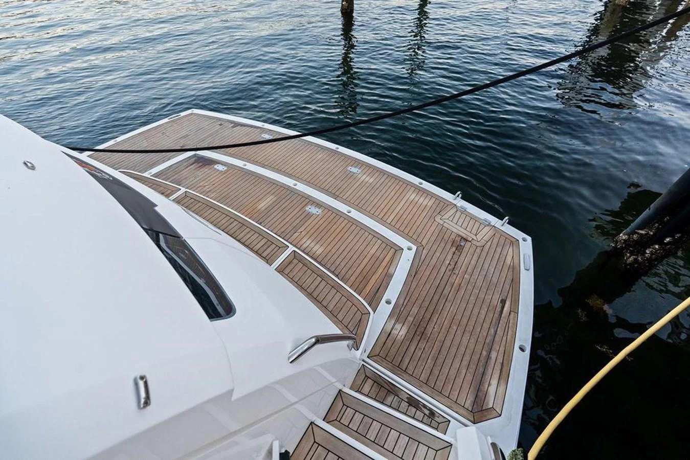 The yacht's swim platform features elegant teak decking and offers easy access to the water. aboard ELLIGANCE Yacht for Sale