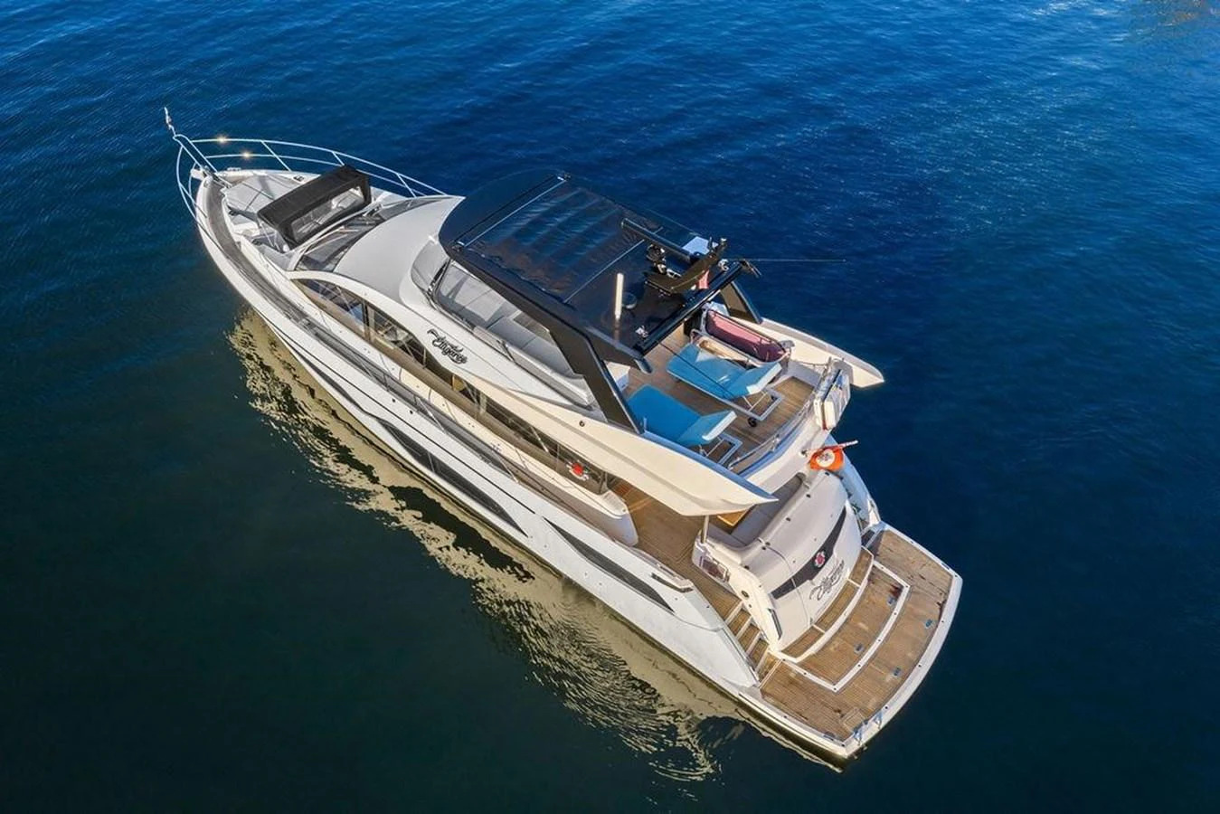 A sleek and modern yacht cruising on calm waters, showcasing its elegant design and spacious deck areas. aboard ELLIGANCE Yacht for Sale