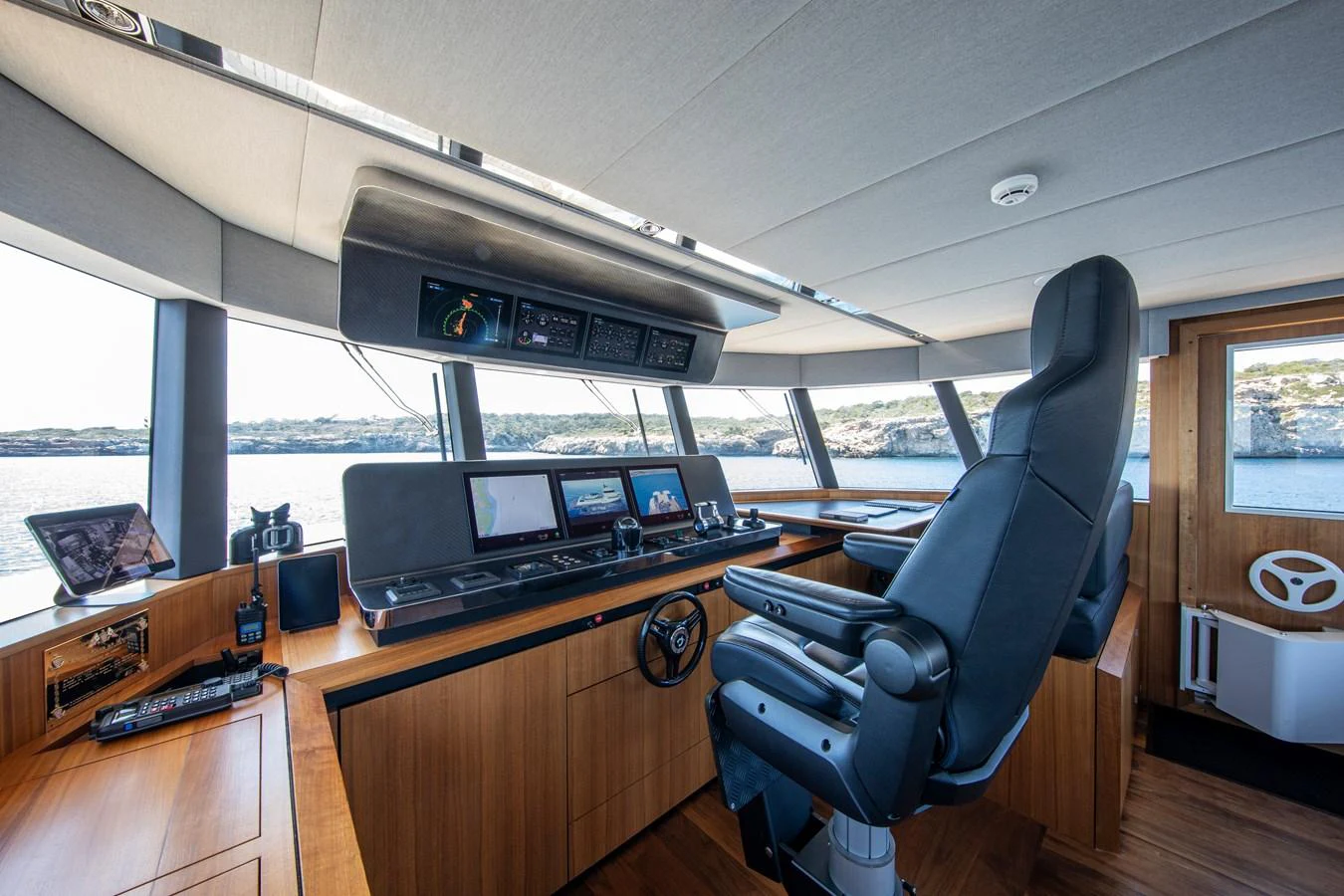The helm station features state-of-the-art navigation equipment and a comfortable captain's chair with panoramic views. aboard PLAYA Yacht for Sale