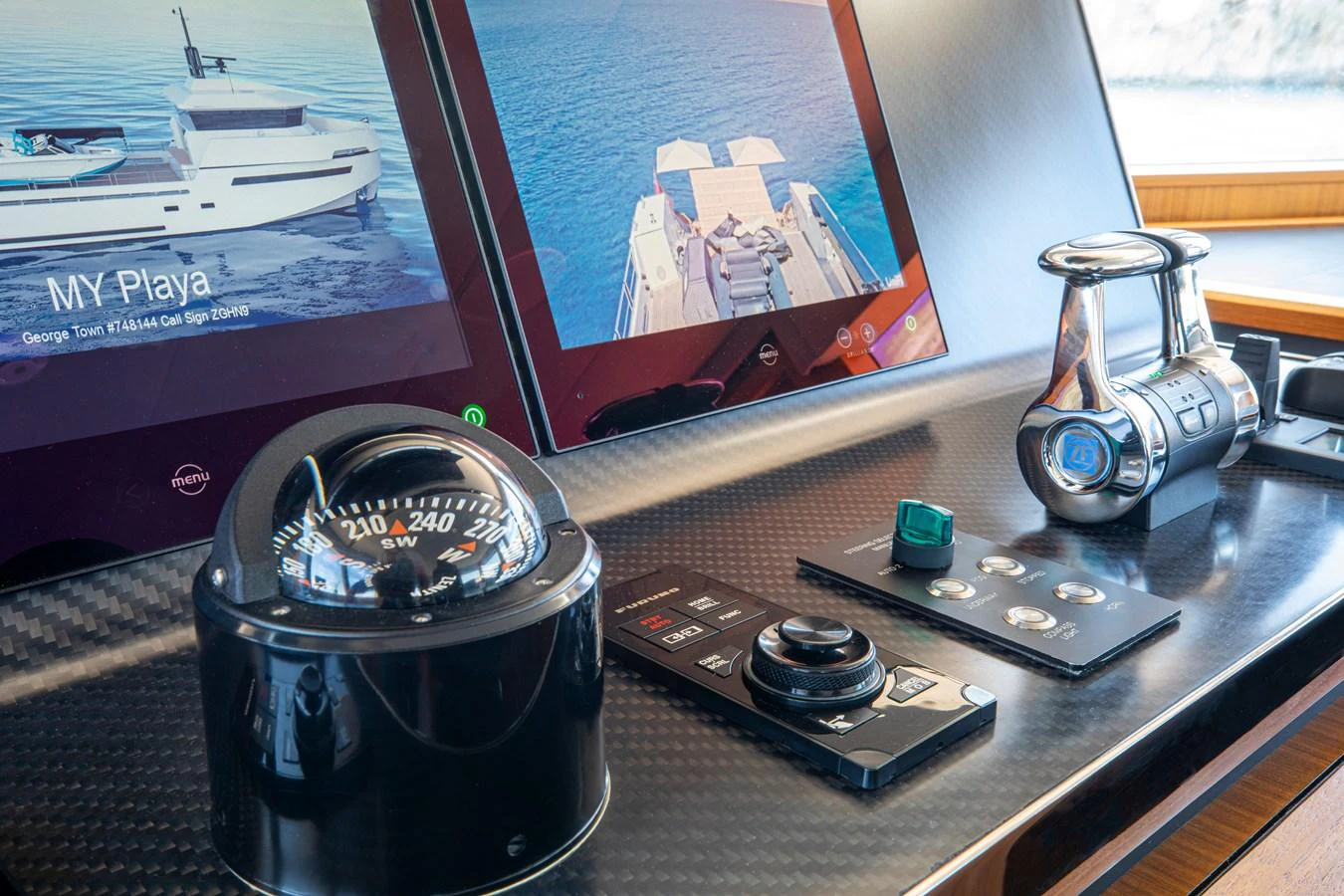 The helm station features advanced navigation equipment and a sleek, modern design. aboard PLAYA Yacht for Sale