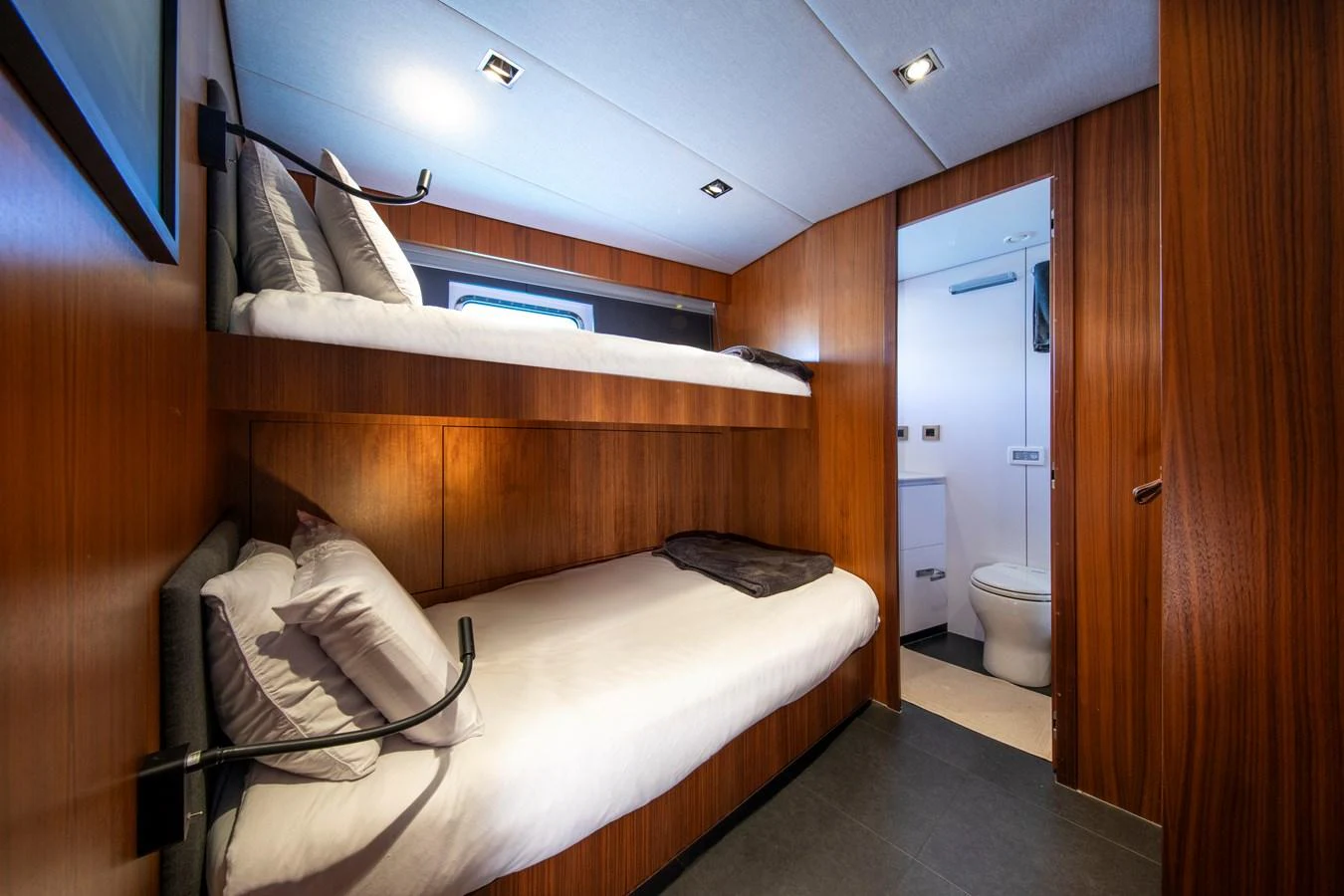 The guest cabin features cozy bunk beds and a private en-suite bathroom, offering comfort and privacy. aboard PLAYA Yacht for Sale