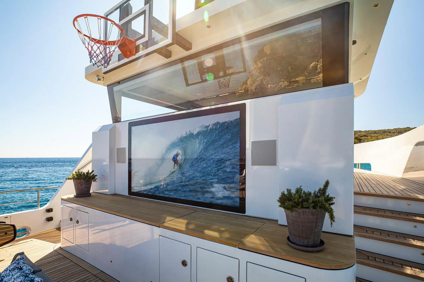 This yacht features an outdoor entertainment area with a large TV and a basketball hoop, perfect for leisure and fun. aboard PLAYA Yacht for Sale