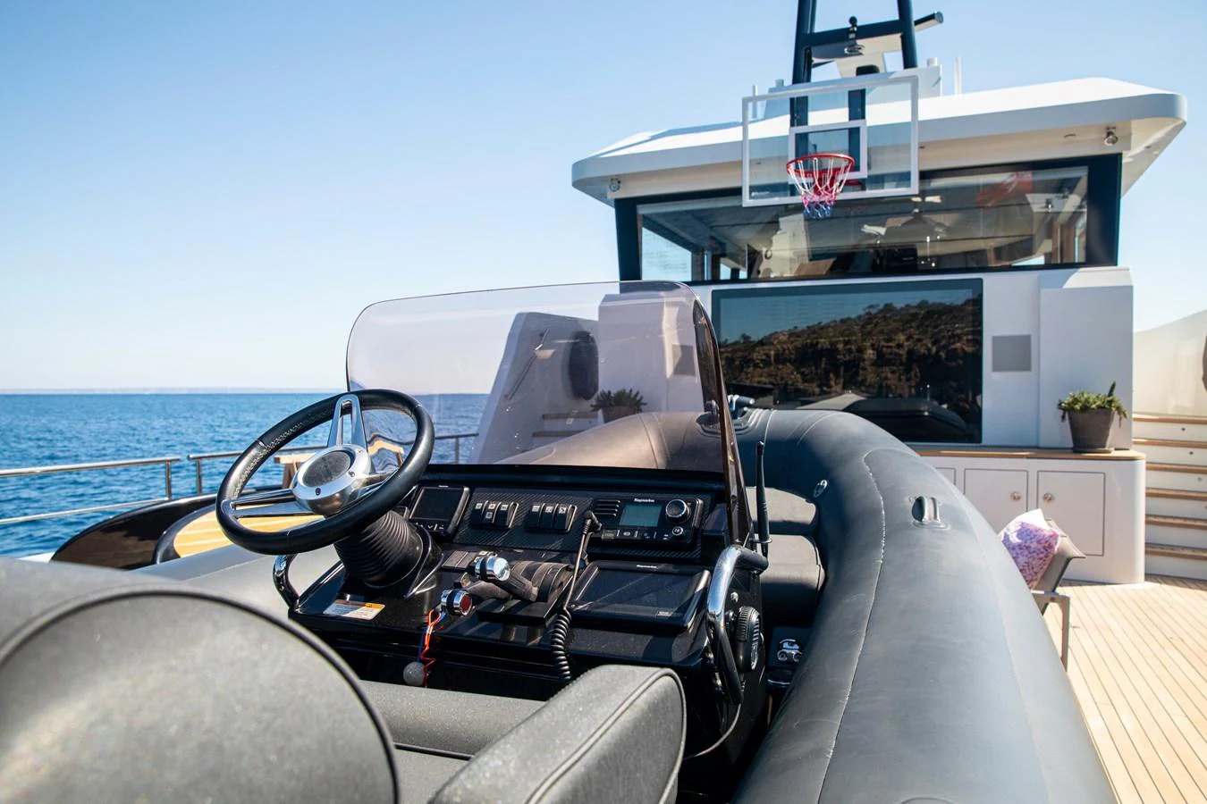 A sleek tender with a modern helm station is positioned on the yacht's deck, ready for adventure. aboard PLAYA Yacht for Sale