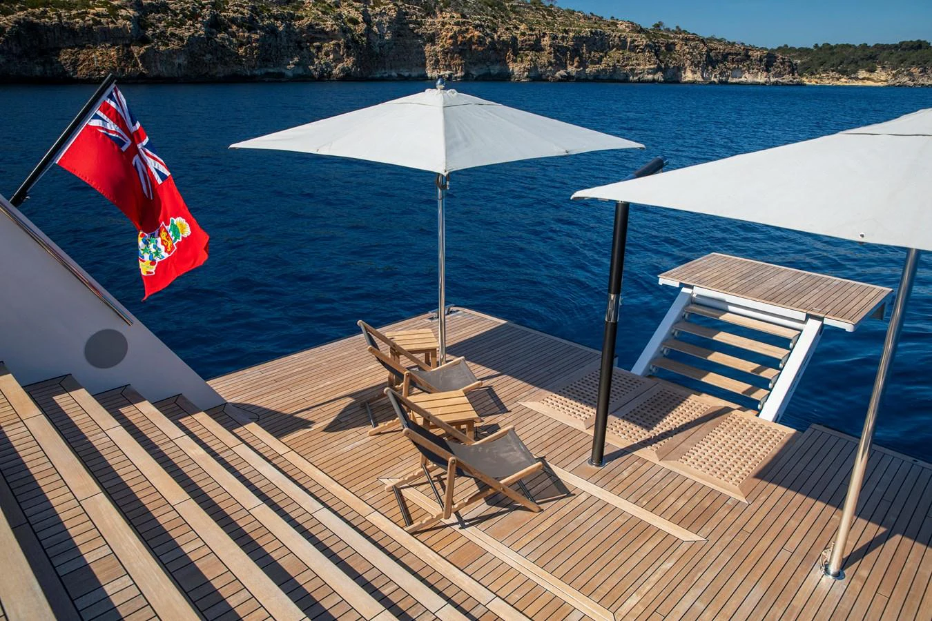 The yacht's beach club offers a serene space with sun loungers and umbrellas, perfect for relaxation by the water. aboard PLAYA Yacht for Sale