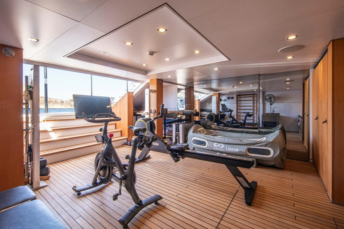 The yacht's gym is equipped with modern fitness machines and offers a bright, spacious environment for workouts. aboard PLAYA Yacht for Sale