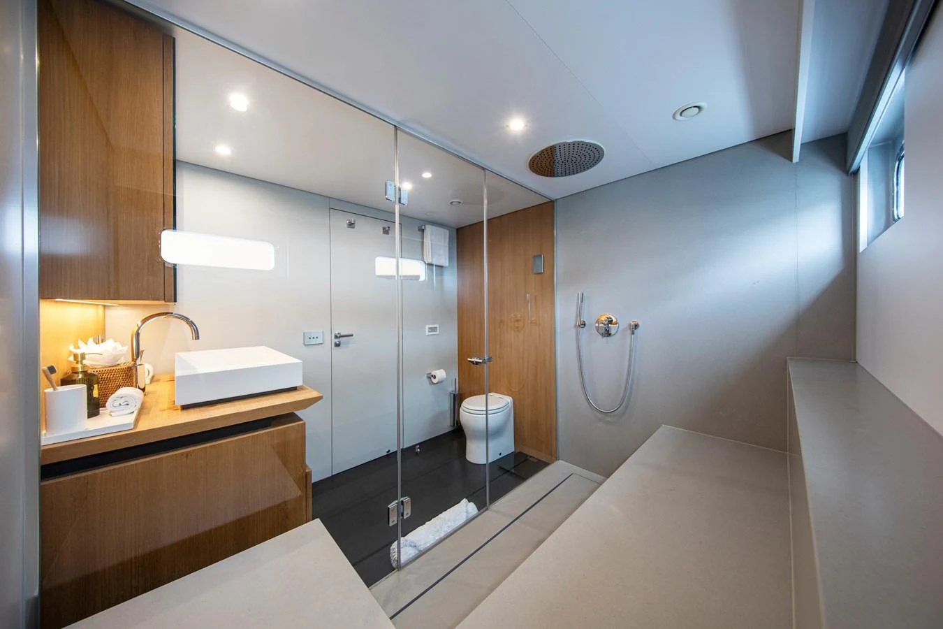 The yacht's bathroom features modern fixtures and a spacious layout with a glass-enclosed shower. aboard PLAYA Yacht for Sale