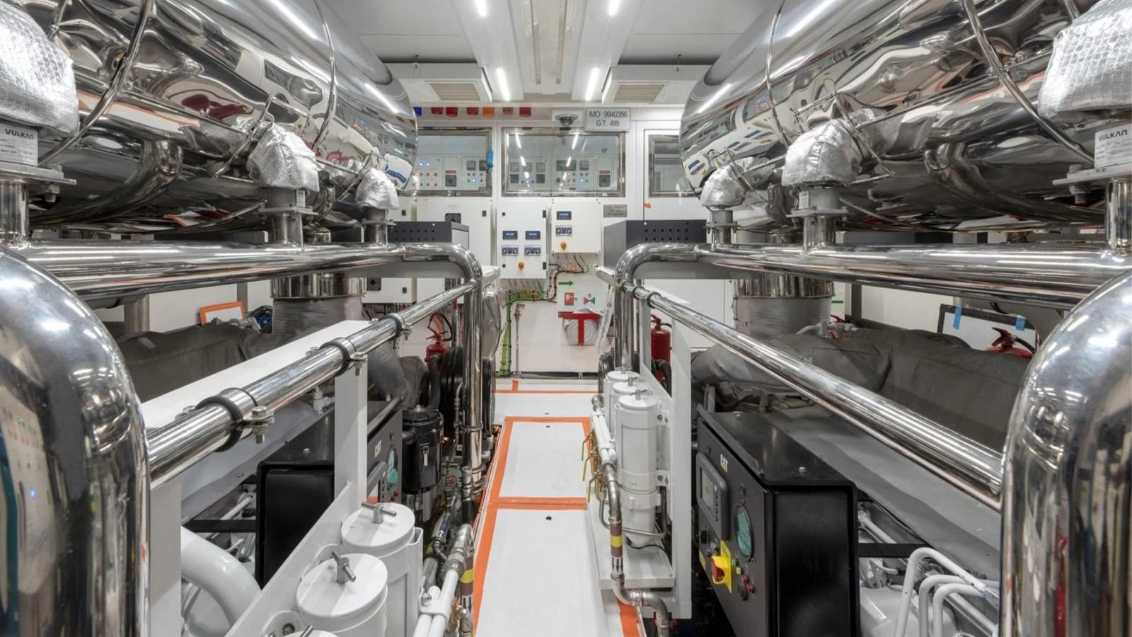 The engine room showcases a pristine and well-organized space with polished metal components and advanced machinery. aboard CASA F Yacht for Sale