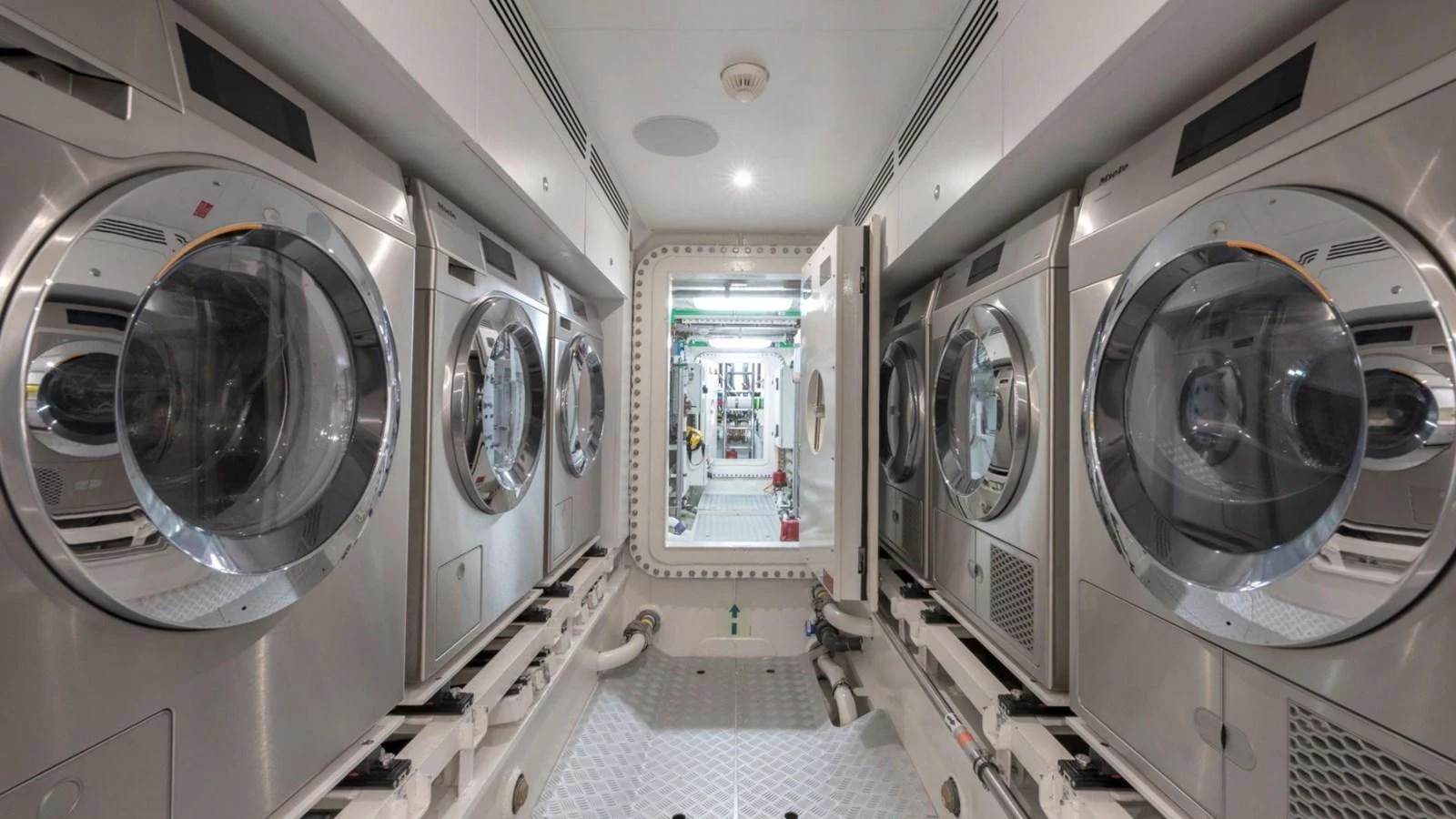The yacht's laundry room is equipped with multiple industrial-grade washing machines and dryers for efficient onboard laundry management. aboard CASA F Yacht for Sale