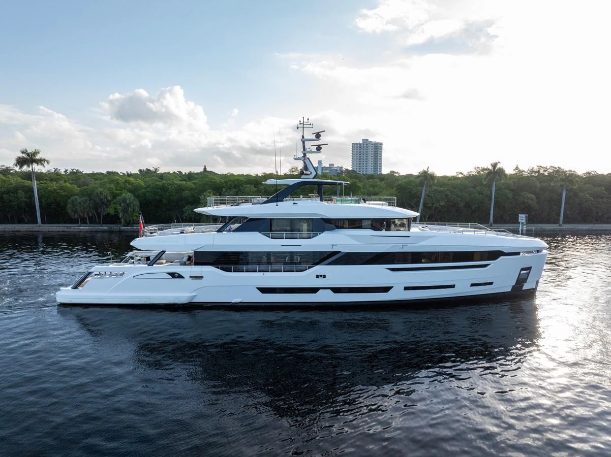 A sleek and modern yacht cruising along a serene waterway with lush greenery in the background. aboard BAGLIETTO DOM 133 #5 Yacht for Sale