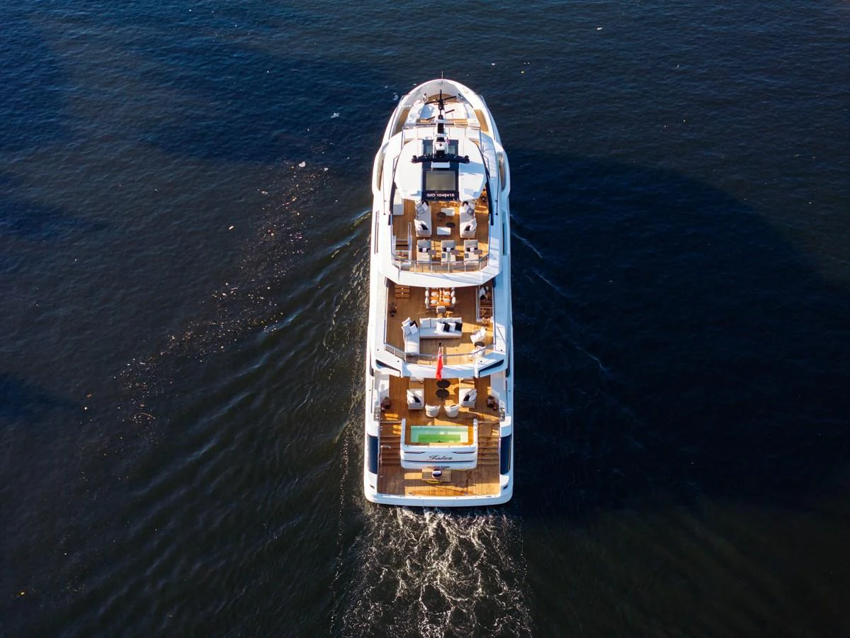 Aerial view of a luxurious yacht cruising on calm waters, showcasing its multiple decks and amenities. aboard BAGLIETTO DOM 133 #5 Yacht for Sale