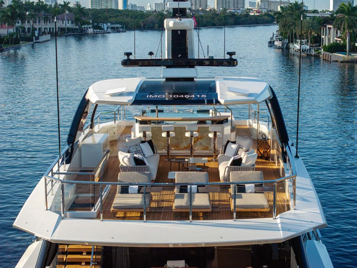 The yacht's aft deck offers a luxurious outdoor seating area with stunning views of the surrounding waterway. aboard BAGLIETTO DOM 133 #5 Yacht for Sale