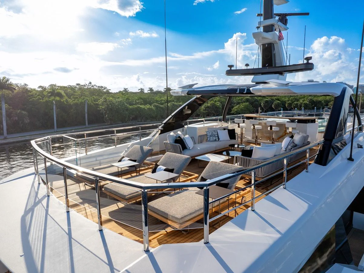 The yacht's aft deck features luxurious lounging areas with sunbeds and a dining space, perfect for relaxation and socializing. aboard BAGLIETTO DOM 133 #5 Yacht for Sale