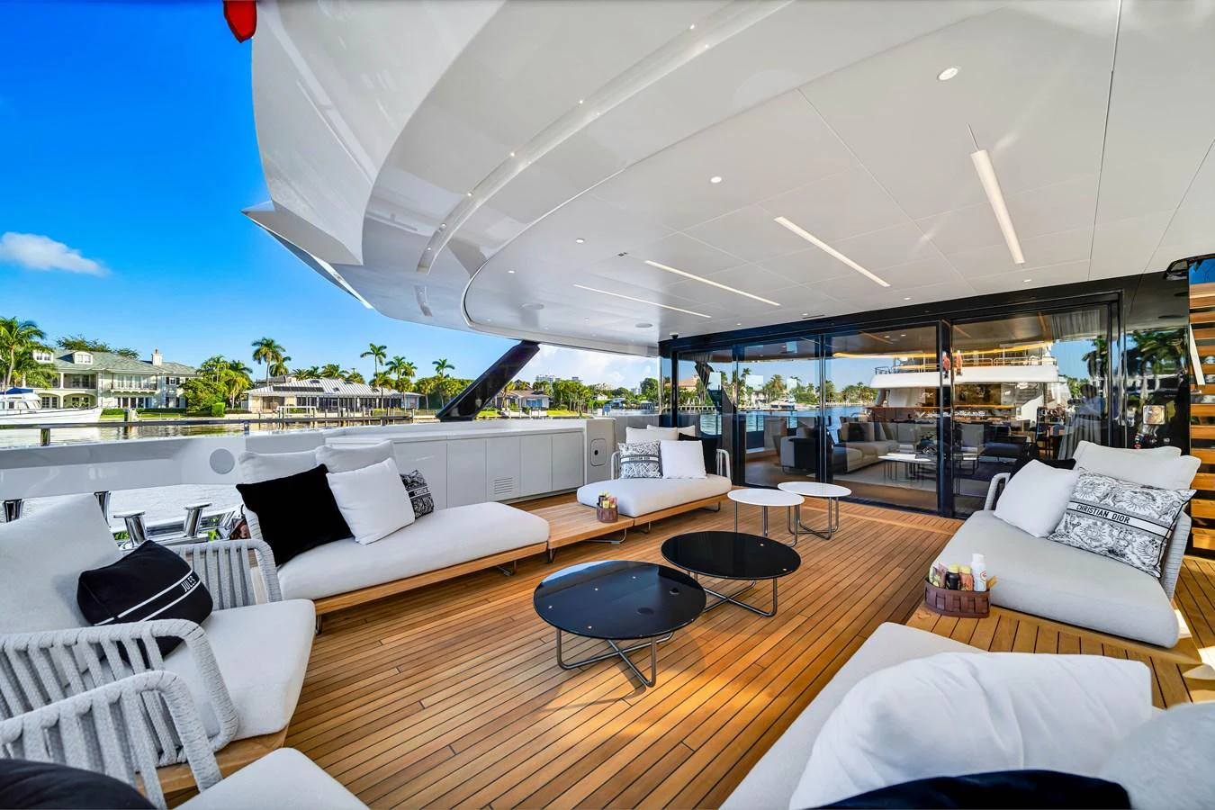 The aft deck features luxurious seating with a seamless transition to the interior living space. aboard BAGLIETTO DOM 133 #5 Yacht for Sale