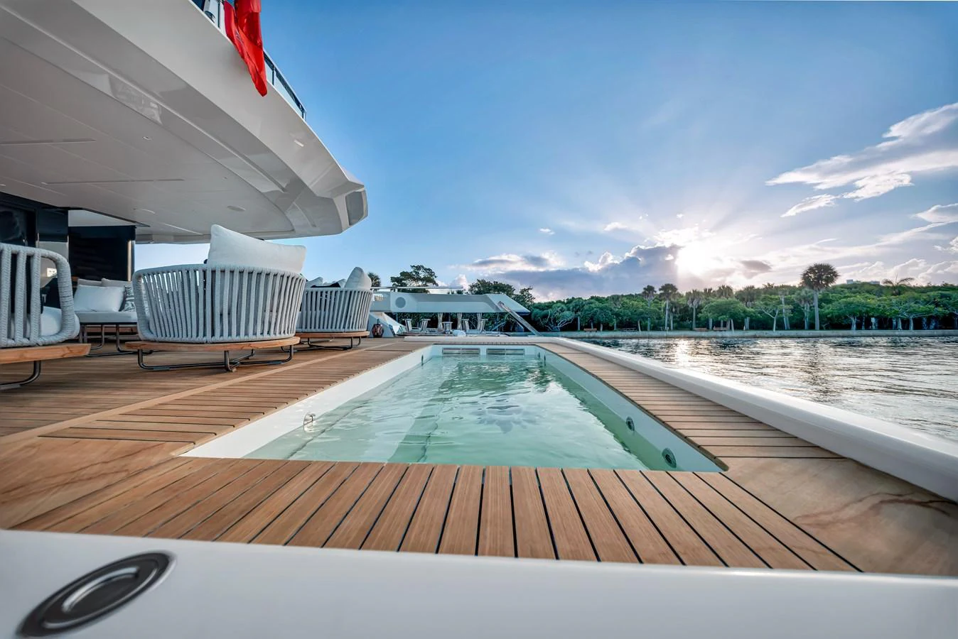 The yacht features a luxurious deck pool with elegant seating and scenic views. aboard BAGLIETTO DOM 133 #5 Yacht for Sale