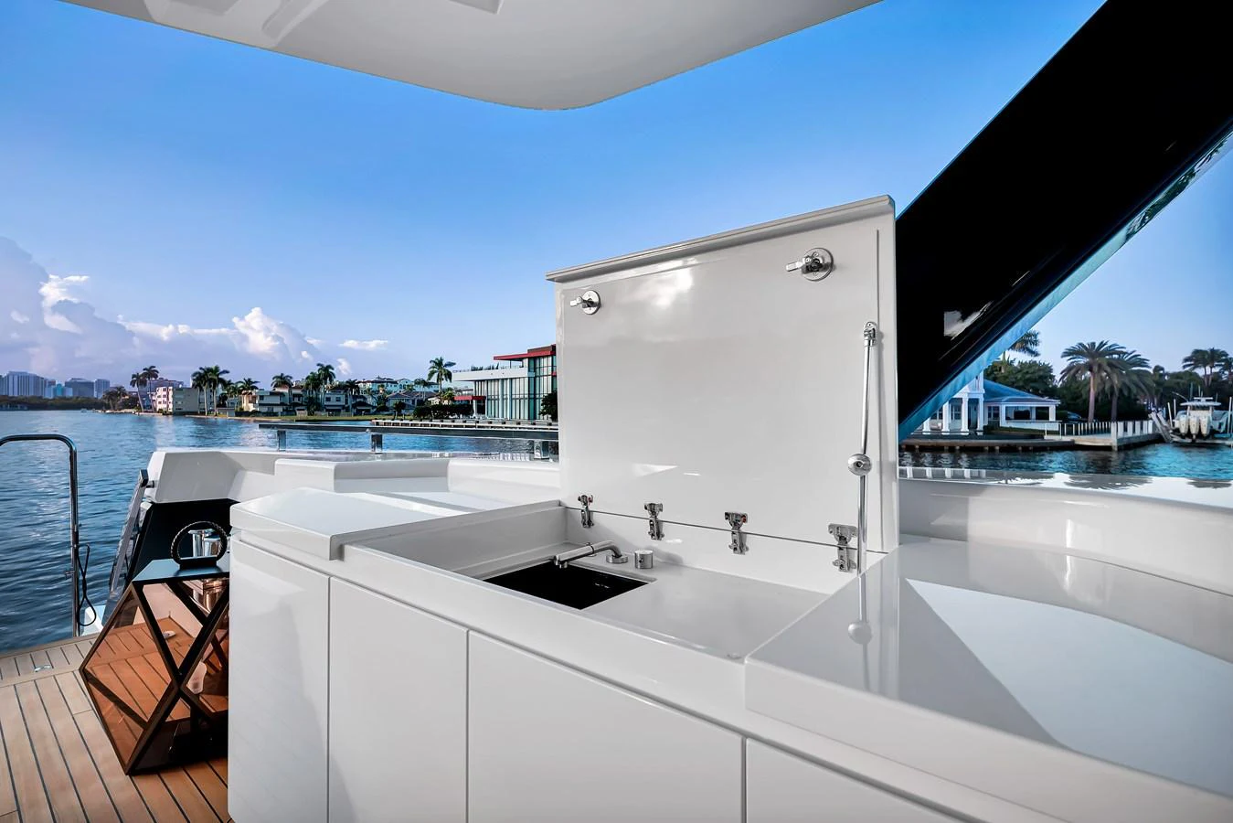 The yacht features a sleek outdoor galley with modern fixtures and a stunning waterfront view. aboard BAGLIETTO DOM 133 #5 Yacht for Sale