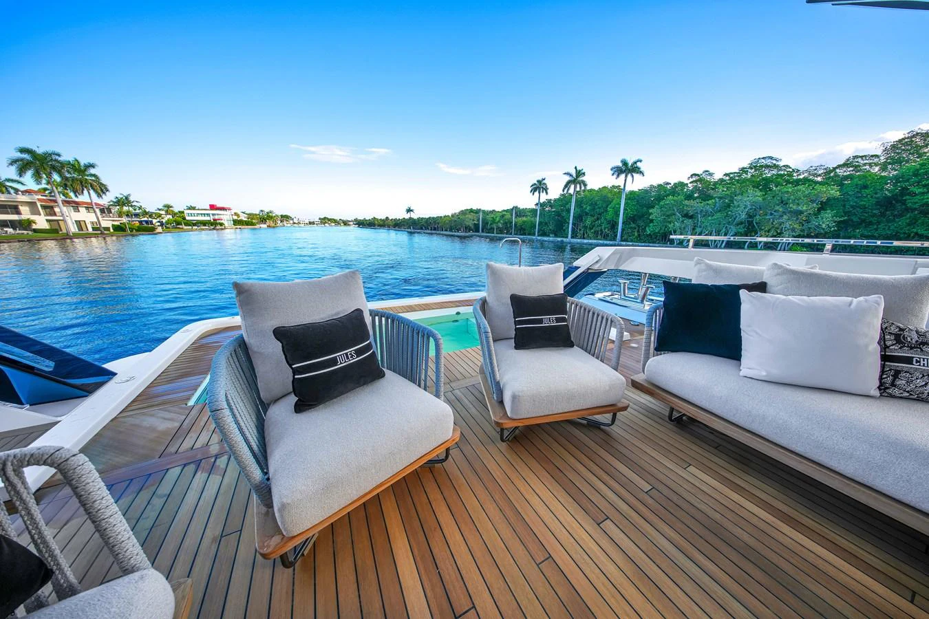The aft deck offers a luxurious outdoor seating area with plush chairs and a stunning view of the water. aboard BAGLIETTO DOM 133 #5 Yacht for Sale