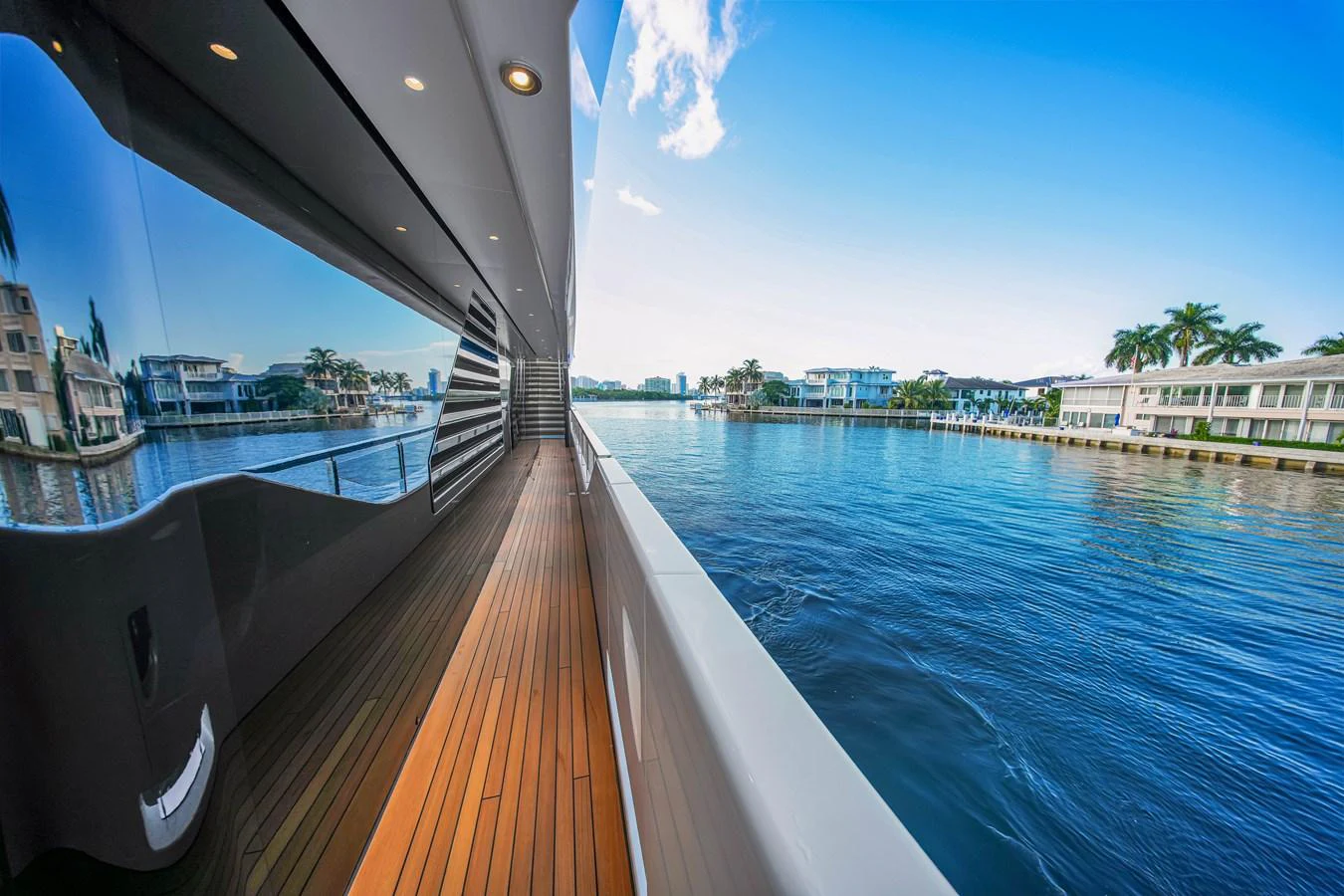 The side deck offers a serene view of the water and nearby waterfront properties. aboard BAGLIETTO DOM 133 #5 Yacht for Sale